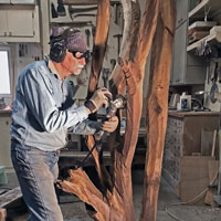 Roughing out sculpture with chainsaw side-grinder.